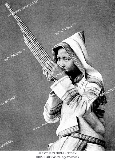 Thailand: An ethnic Karen from northern Thailand playing a 'khaen', or Lao flute, c. 1900