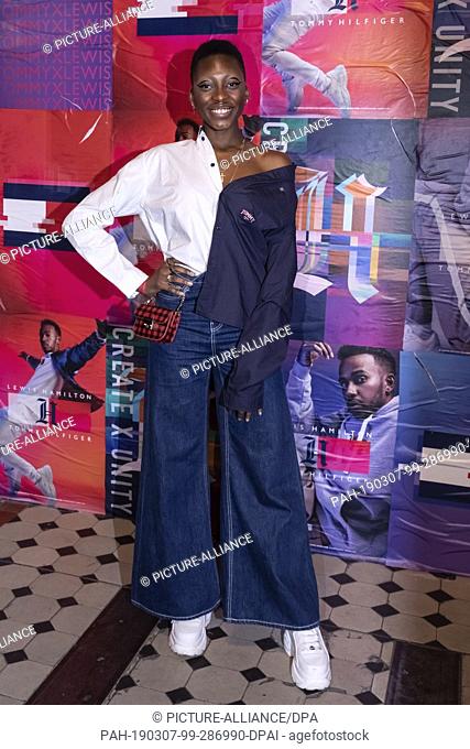 07 March 2019, Berlin: Toni Dreher-Adenuga, model, stands in front of a photo wall at the Tommy Hilfiger CREATExUNITY event
