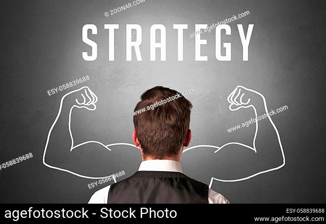 Rear view of a businessman with STRATEGY inscription, powerfull business concept