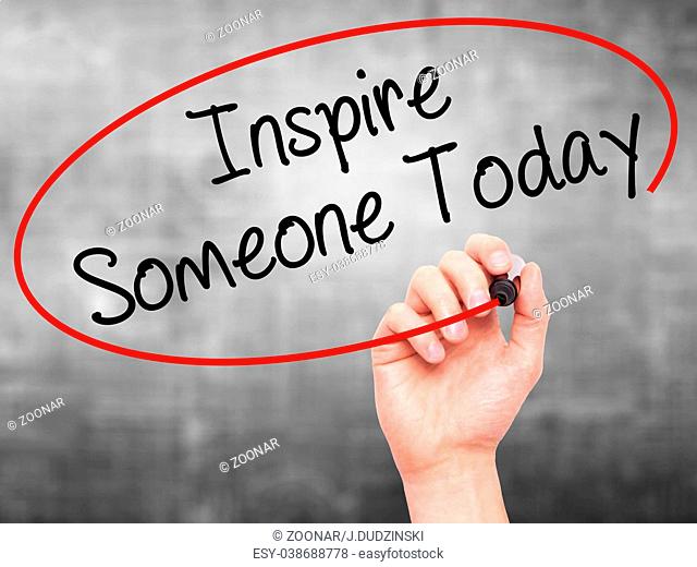 Man Hand writing Inspire Someone Today with black marker on visual screen