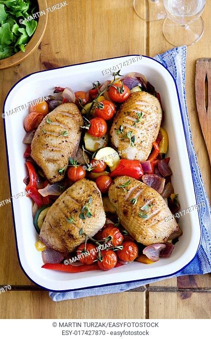 Roasted duck breasts with vegetables and herbs