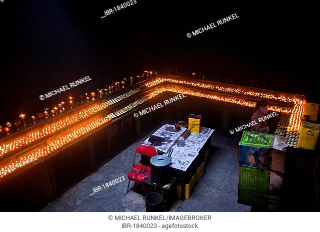 Dark room with many prayer candles in Ramoche Temple, Lhasa, Tibet, Asia