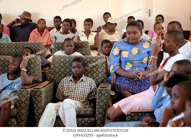 Chidren listen to a speech about self respect during a staff Christmas party at the Howard Hospital in Zimbabwe. The children aged 10 and up to late teens enjoy...