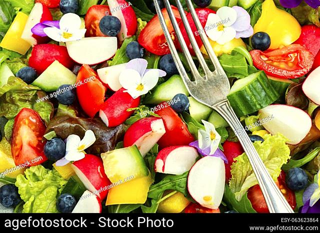 Vegan salad with vegetable and edible flowers. Clean eating