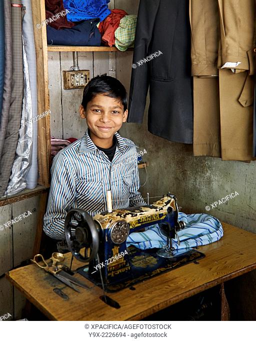 A young boy working as a tailor in Darjeeling