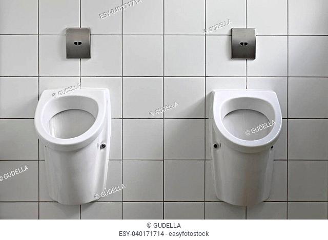 Public toilet interior with pissoirs