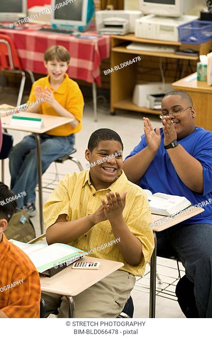 Students clapping in classroom