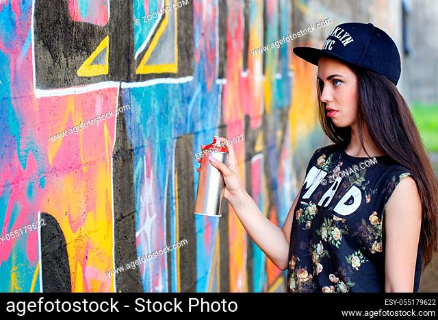 Street, outdoor. Attractive teen in a cap