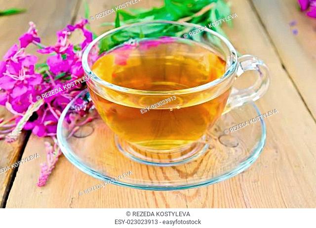 Herbal tea in glass cup of fireweed on board