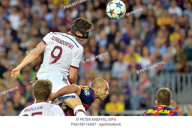 Barcelona's Javier Mascherano (bottom) and Munich's Robert Lewandowski vie for the ball during the UEFA Champions League semi-final first leg soccer match...