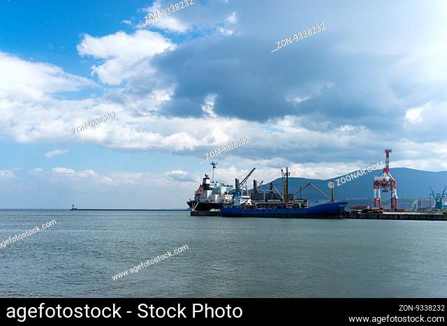 cargo ship parks against dock in hokkaido in cloud sky