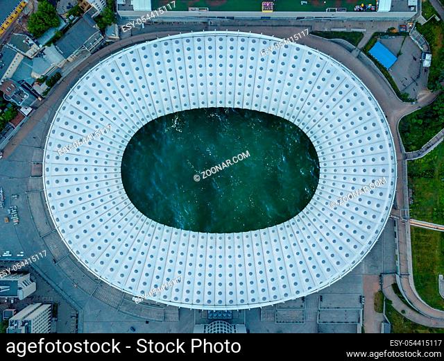Birds eye panoramic view from drone of the football stadium with ocean turquoise water inside roof. Top view