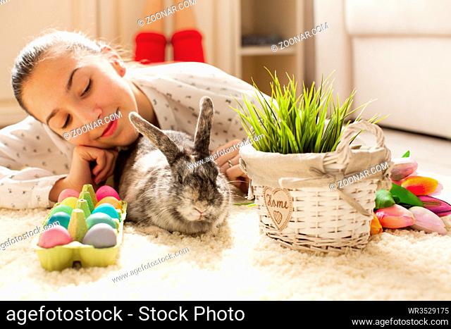 Easter rabbit in home with eggs and green grass