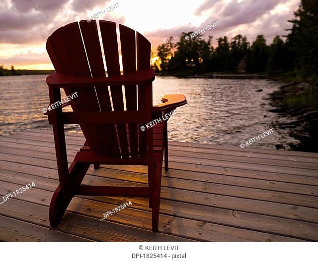 Lake of the Woods, Ontario, Canada, Adirondack chairs on a dock