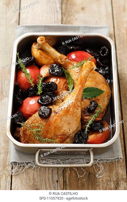 Roast duck leg with dried plums and apples