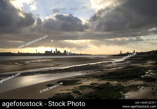 Low tide on a Merseyside beach with view to land, Liverpool, England, UK