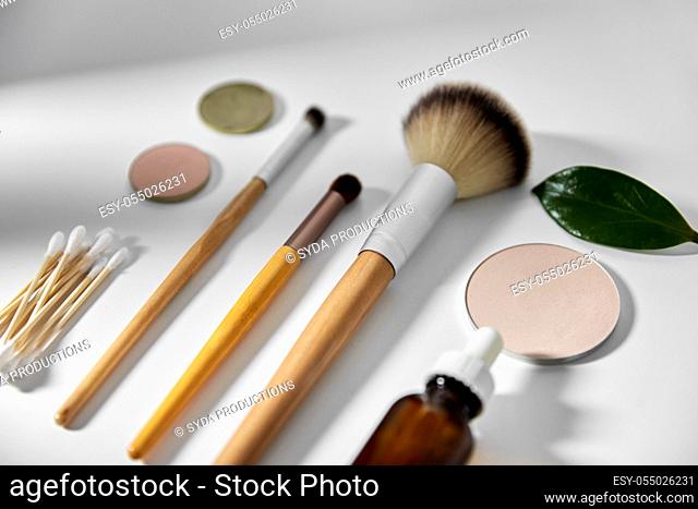 make up brushes, cosmetics and cotton swabs