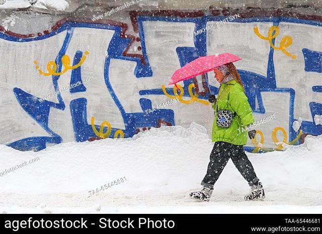 RUSSIA, MOSCOW - DECEMBER 3, 2023: A woman walks in a street during a snowfall. Mikhail Sinitsyn/TASS