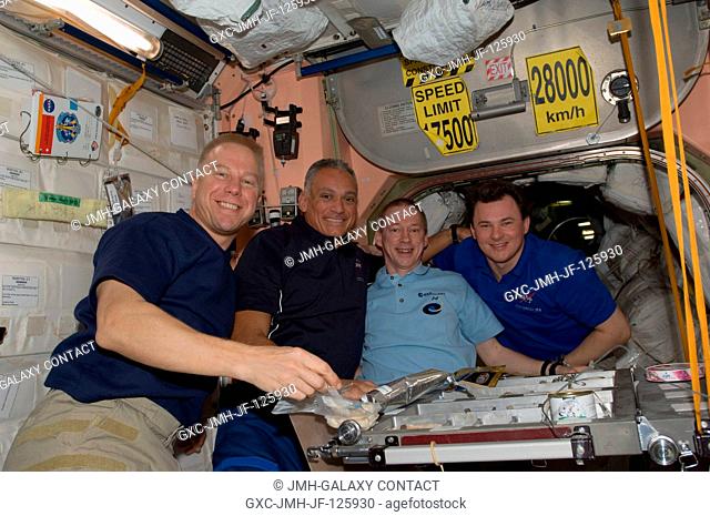 NASA astronauts Tim Kopra (left) and John Danny Olivas, both STS-128 mission specialists; along with European Space Agency astronaut Frank De Winne and Russian...