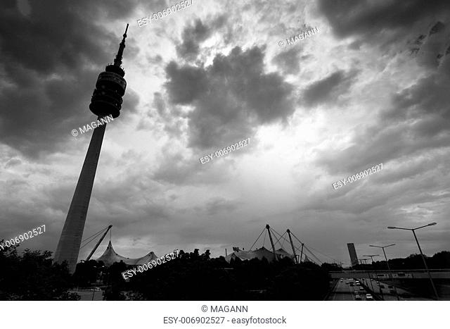the famous olympia tower in munich under a dramatic sky