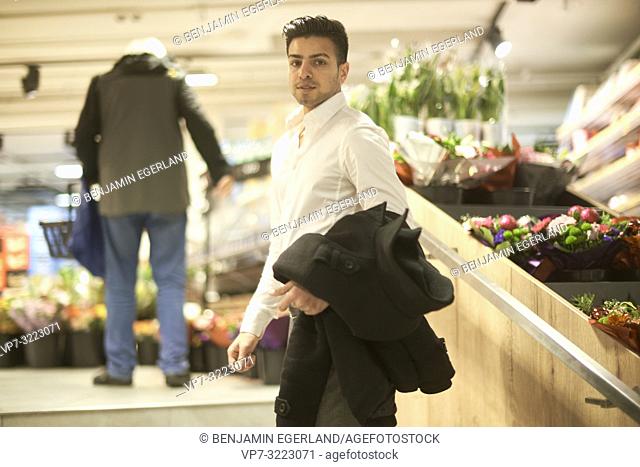young man in flower store, in Munich, Germany