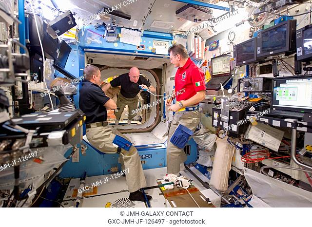Russian cosmonaut Dmitry Kondratyev (left), Expedition 27 commander; NASA astronaut Scott Kelly (center), Expedition 26 commander; and European Space Agency...