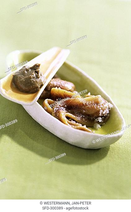 Anchovy paste and anchovies in a small bowl