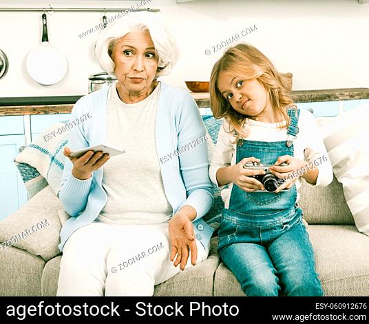 White Haired Italian Grandmother Trying To Understand New Technologies In Granddaughers New Smartphone While Granddaughter Is Not Happy With Grannys Old Film...