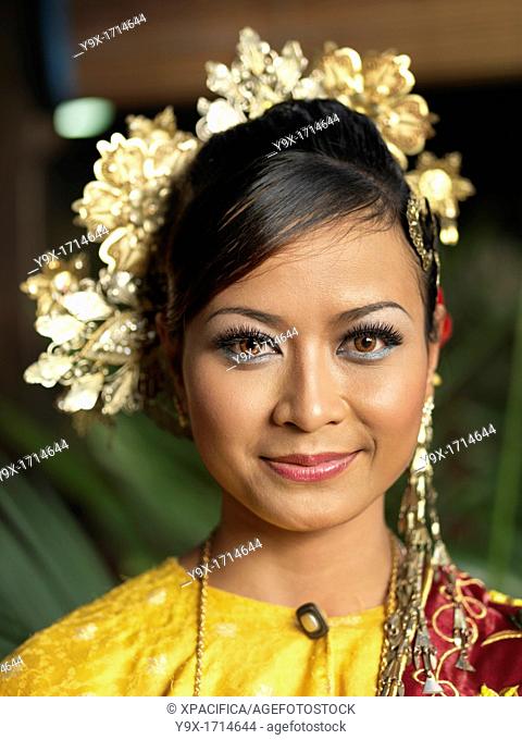 A portrait of Traditional Malaysian dancer wearing a headpiece and stage Make-Up