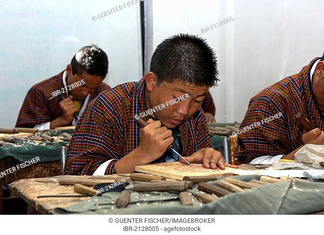 Highly concentrated students doing an apprenticeship in woodcarving at the National Institute of Traditional Arts and Crafts, Zorig Chusum, Thimphu, Bhutan