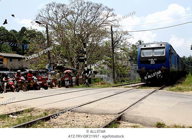 RAILWAY CROSSING & BLUE TRAIN; PERADENIYA, SRI LANKA; 12/03/2013