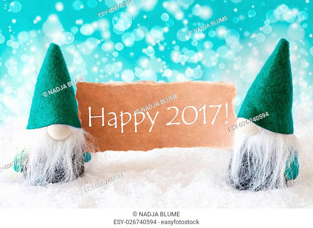 Christmas Greeting Card With Two Turqoise Gnomes. Sparkling Bokeh Background With Snow. English Text Happy 2017