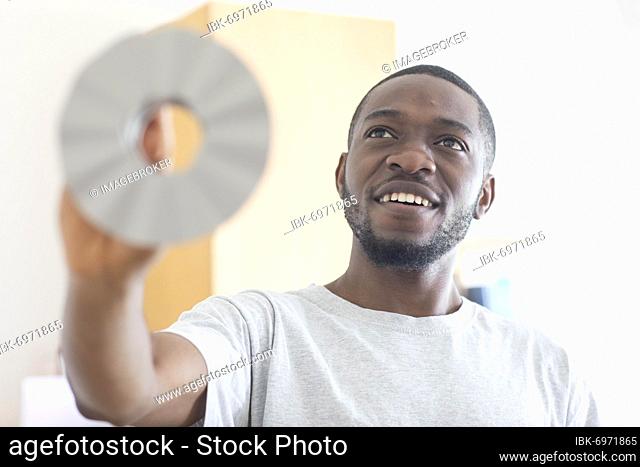 Young black man holding an idea as an invention, vision, innovation, Freiburg, Baden-Württemberg, Germany, Europe
