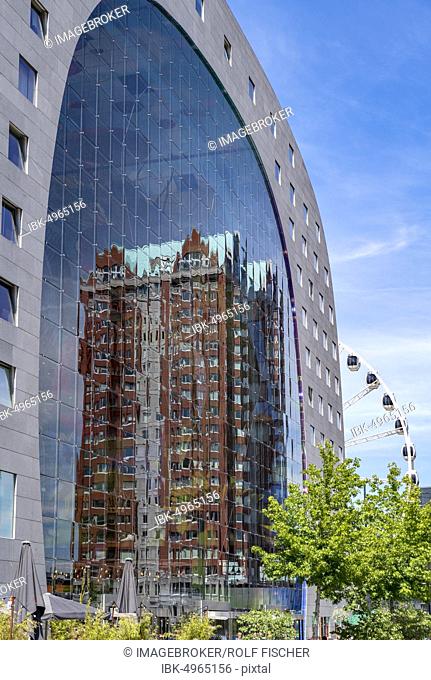 Statendam residential tower reflected in the glass façade of the market hall, Rotterdam, Netherlands