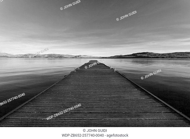 Wooden jetty reaching towards the horizon, Loch Lomond, Scotland, UK