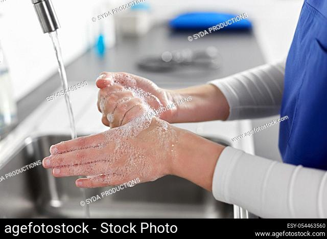 doctor or nurse washing hands with liquid soap