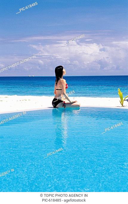 Korean Woman Practicing Yoga at the Beach, Maldives