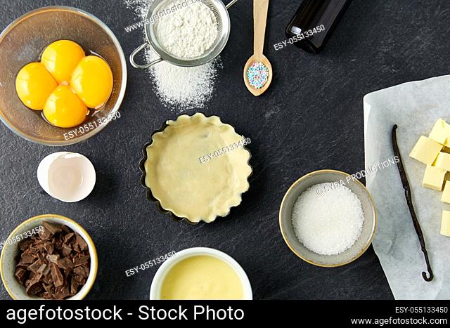 baking dish with dough and cooking ingredients