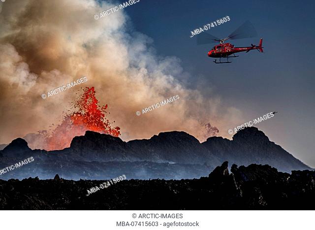 Helicopter flying over the volcano eruption at the Holuhruan Fissure, Bardarbunga Volcano, Iceland. August 29, 2014 a fissure eruption started in Holuhraun at...