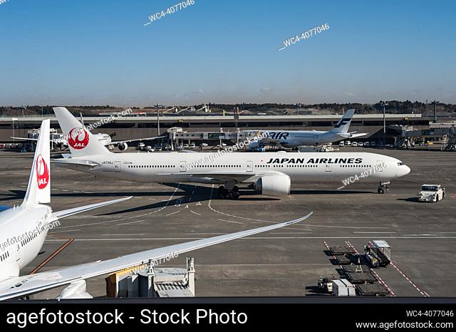 Tokyo, Japan, Asia - Japan Airlines (JAL) passenger aircrafts at Tokyo-Narita International Airport. A Boeing 787 Dreamliner jet is seen parked at a gate in the...
