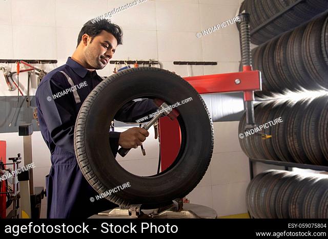 Technician working on the quality of a tyre at a tyre shop