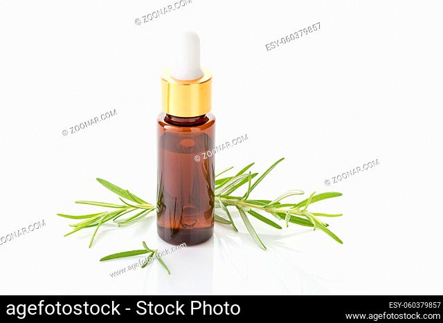 Rosemary essential oil isolated on white background. Rosmarinus officinalis