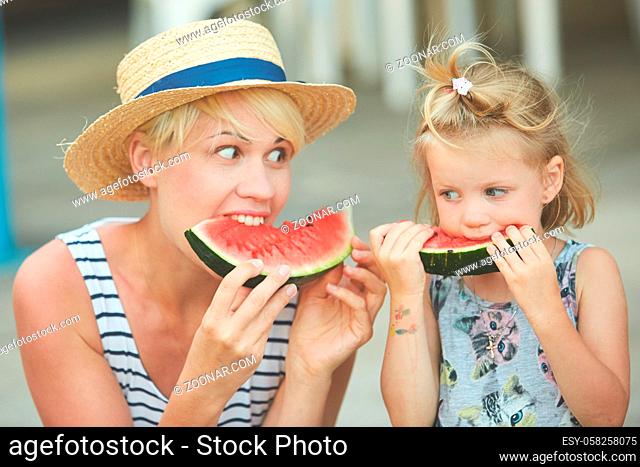 Mother And Daughter Enjoying Slices Of WaterMelon. Film camera style