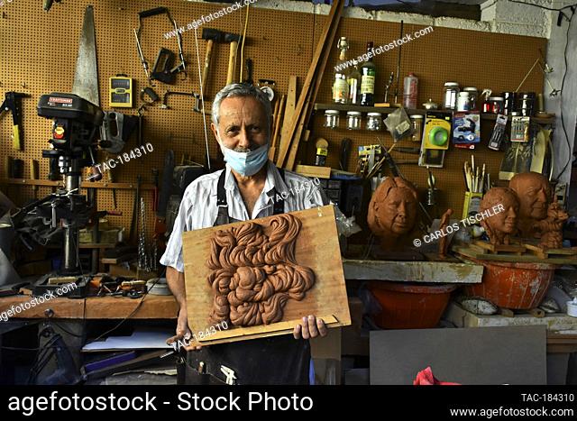 TEPOZTLAN, MEXICO - DECEMBER 13, 2020: Guatemalan sculptor Edgar Guzman Schwartz , 69 , performing of a sculpture makes of plasticine in his workshop in...