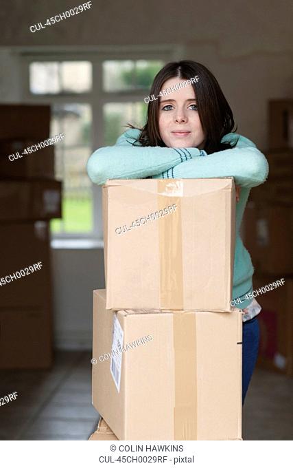 Teenage girl leaning on cardboard box