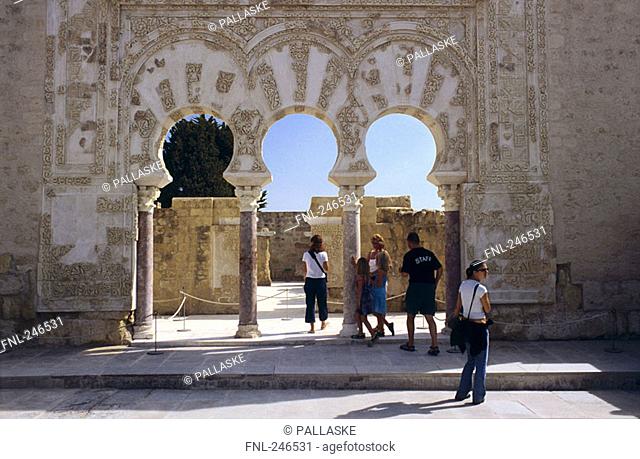 Tourists looking ruins of castle, Portico de Medina Azahara, Medina Azahara, Cordoba, Andalusia, Spain