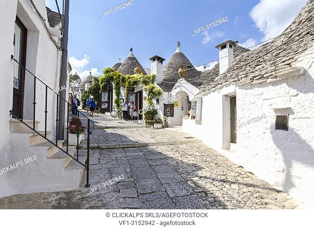 View of the typical Trulli huts and the alleys of the old village of Alberobello. Province of Bari, Apulia, Italy, Europe