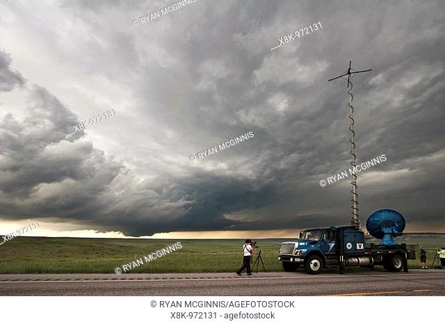 Storm chasers with Project Vortex 2 watch a distant wall cloud and supercell in Goshen County, Wyoming, June 5, 2009  The truck at right is the 'Doppler on...
