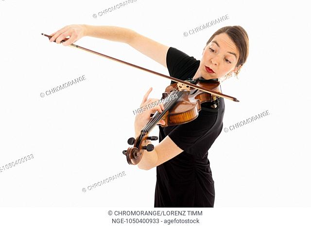 The beautiful young woman is playing the violin