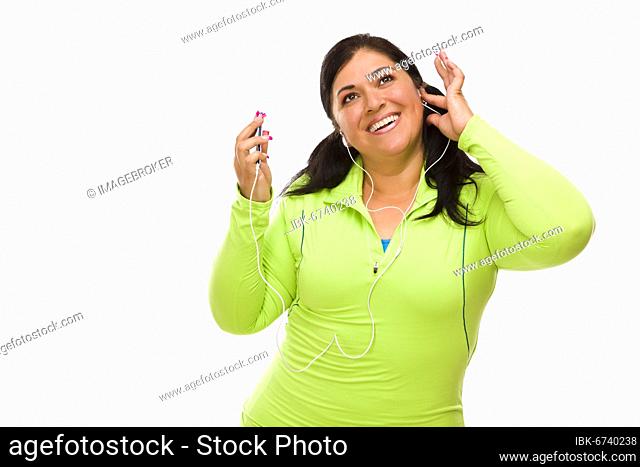 Attractive middle aged hispanic woman in workout clothes with music player and headphones against a white background